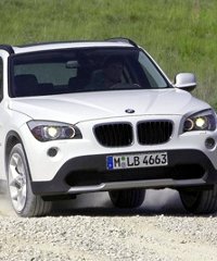 Adili Popat, chief executive officer of Bavaria Auto, next to the new 2010 BMW X1 series launched at the Nairobi showroom in Kenya yesterday.