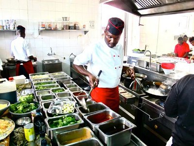 A chef working in the Bamboo Oriental restaurant's kitchen. A chef working in the Bamboo Oriental restaurant's kitchen.