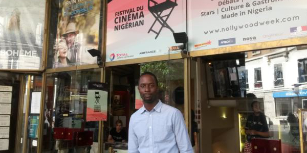Festival organiser Serge Noukoue in front of the Paris cinema airing the Nollywood Week film festival. Photo by Lisa Bryant / VOA