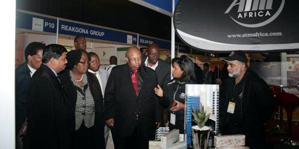 The City of Joburg’s Reginald Pholo (third from right) visits one of the CoJ Pavilion exhibitors at SAITEX 2014.