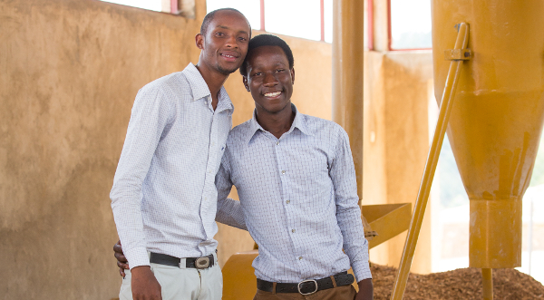 Jean Bosco Nzeyimana (right) and his company's waste crunching machine
