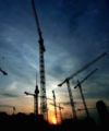 What are the new trends driving private infrastructure investment in emerging markets? Construction-cranes 200x240
