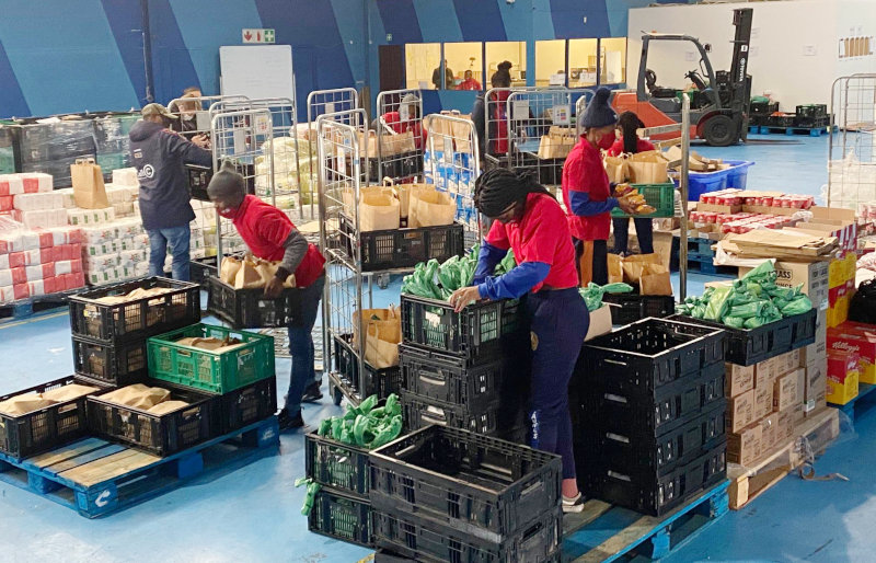 Employees preparing orders at Yebo Fresh's warehouse.
